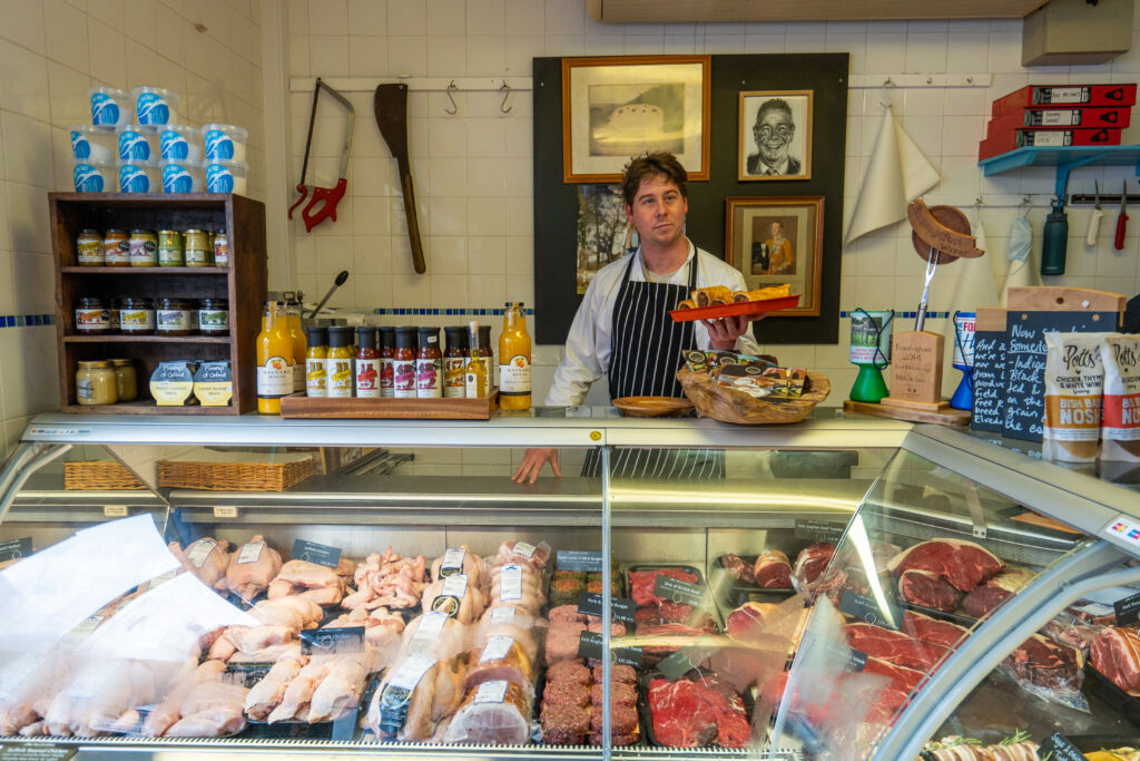 Man standing at butcher's counter